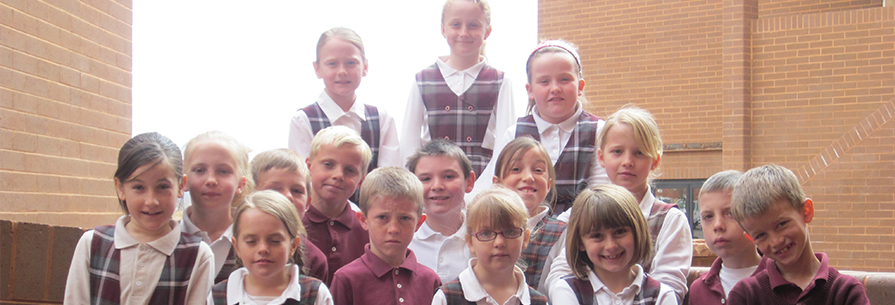 Group of smiling students pose together outside