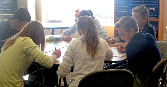 Group of students sitting at a classroom table