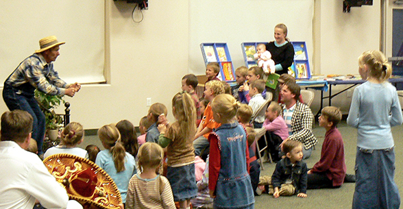 Students and staff members participate in a storytime activity