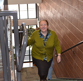 Staff member walking up a stairwell