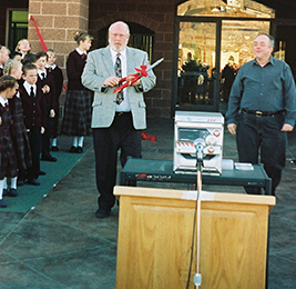 Staff member walks to a podium as students watch