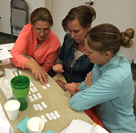 Staff members work on a project together