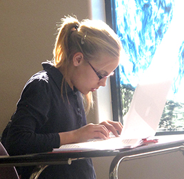 Student using a laptop at her desk
